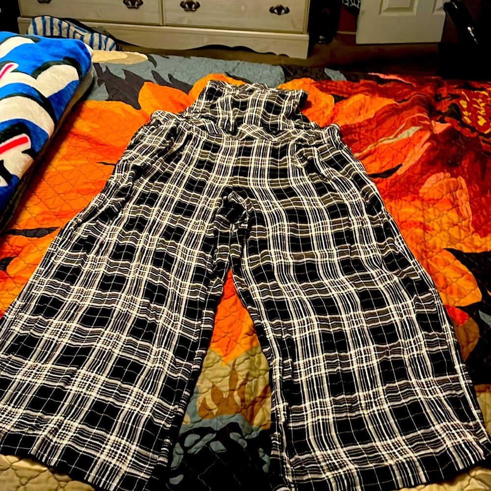 Stripped Overalls with pockets and elastic in the back of the pants.
